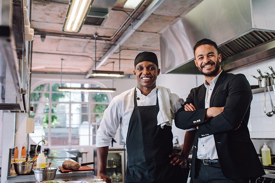 Specialized Business Insurance - Restaurant Owner with Head Chef in the Kitchen